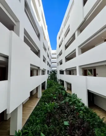 white building with multiple floors and a central garden