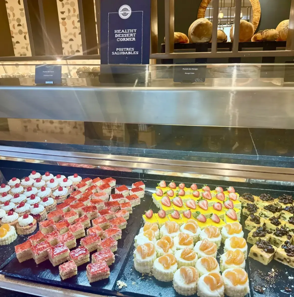 Dessert display with various cakes and pastries in a glass case