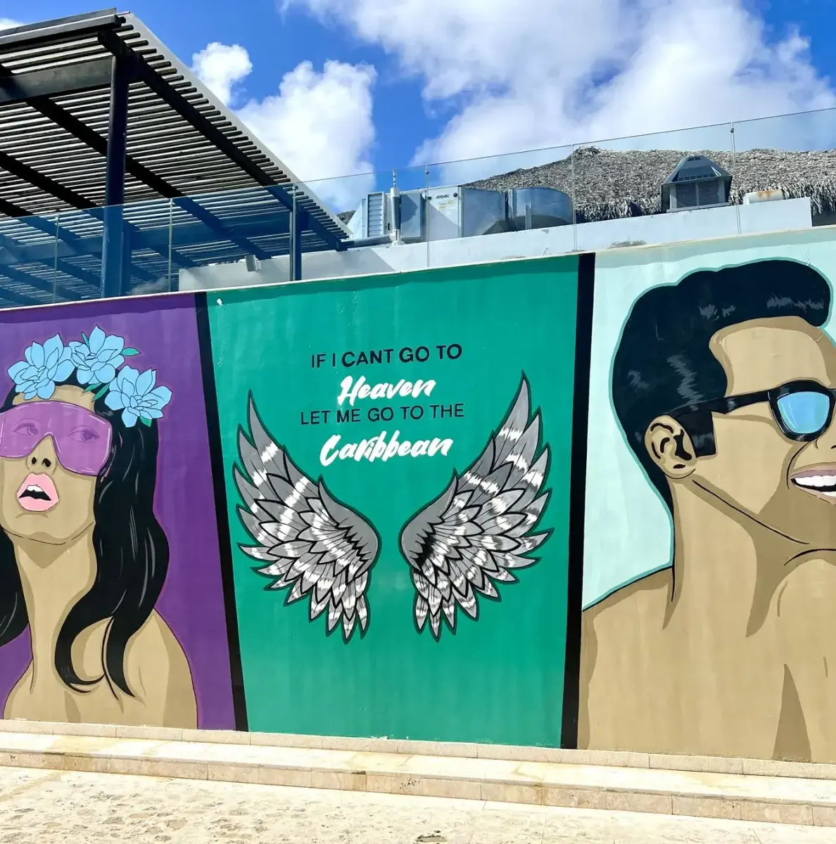 mural with woman, wings, man, and text on a wall