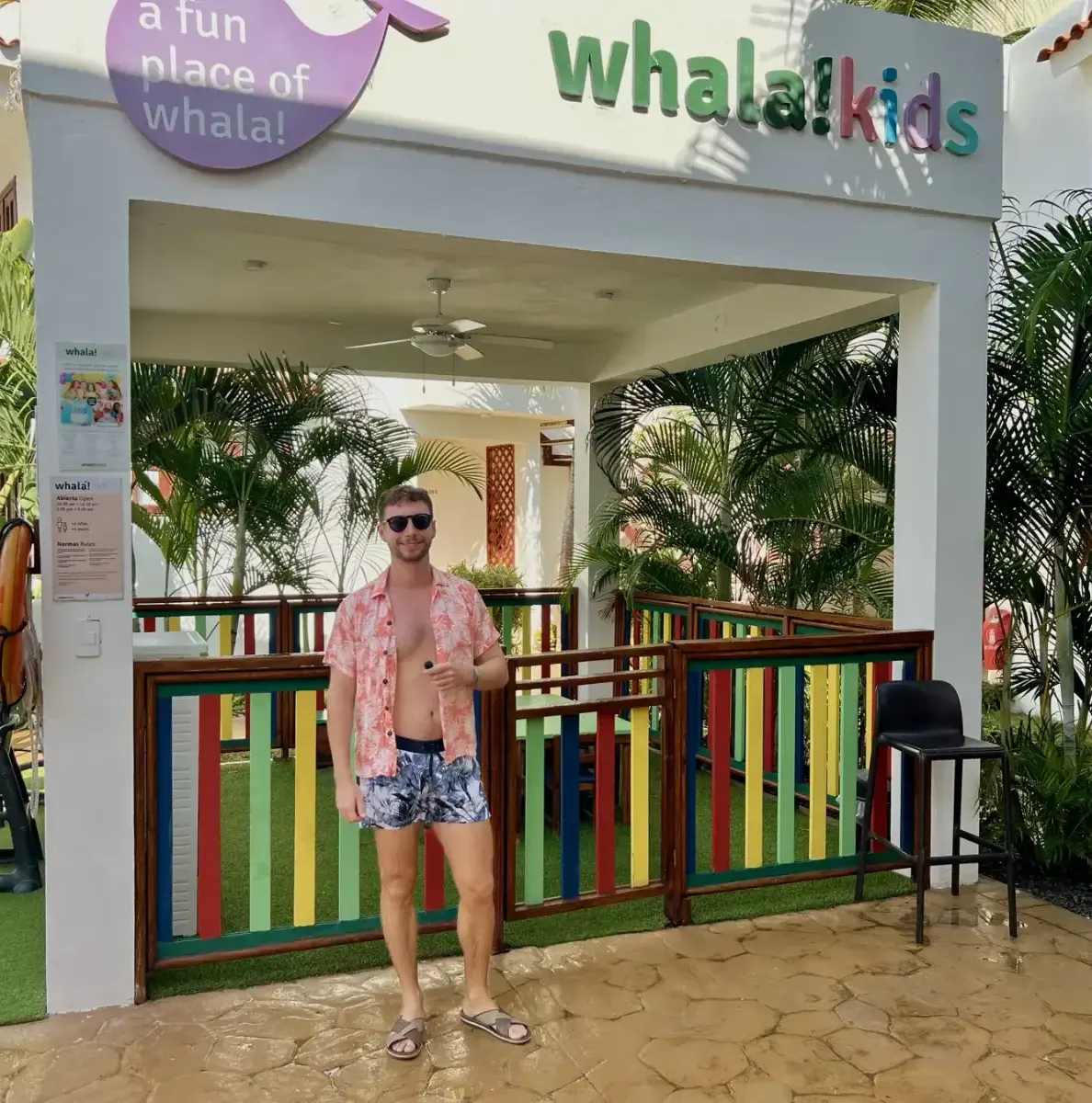 Man standing in front of a kids club area with colorful railings