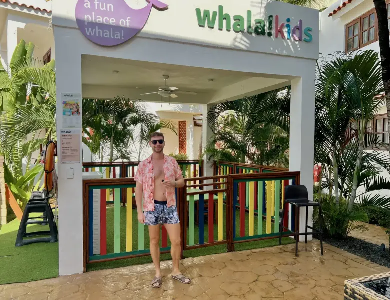 Man standing in front of a kids club area with colorful railings