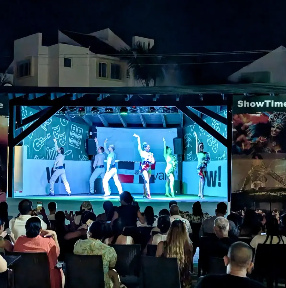 stage with performers, audience watching, ShowTime banners