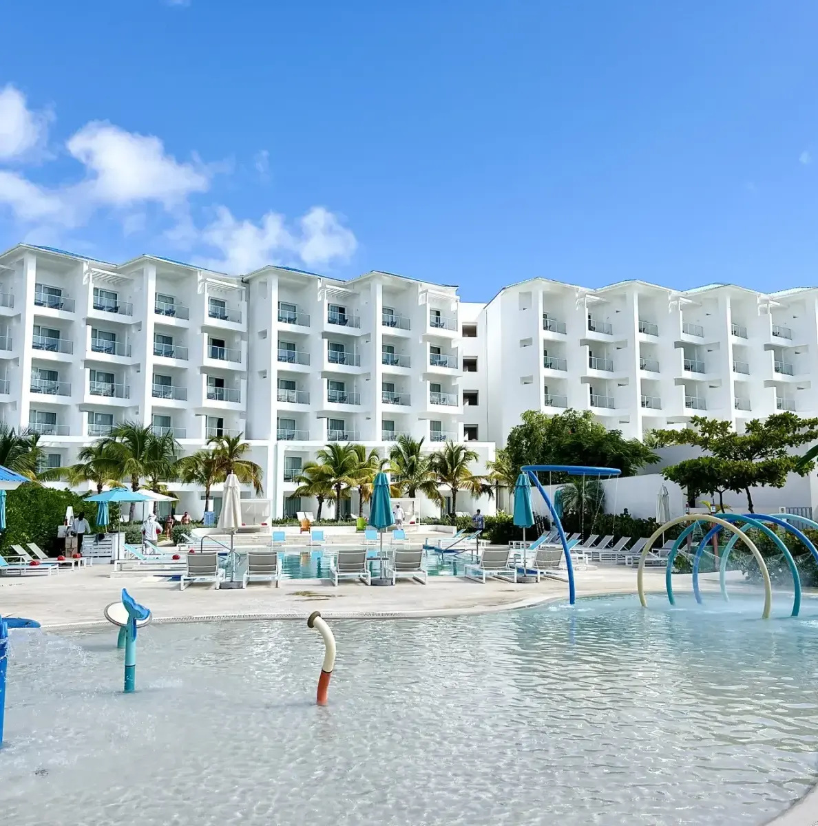 Waterpark with slides, pool, and white resort building
