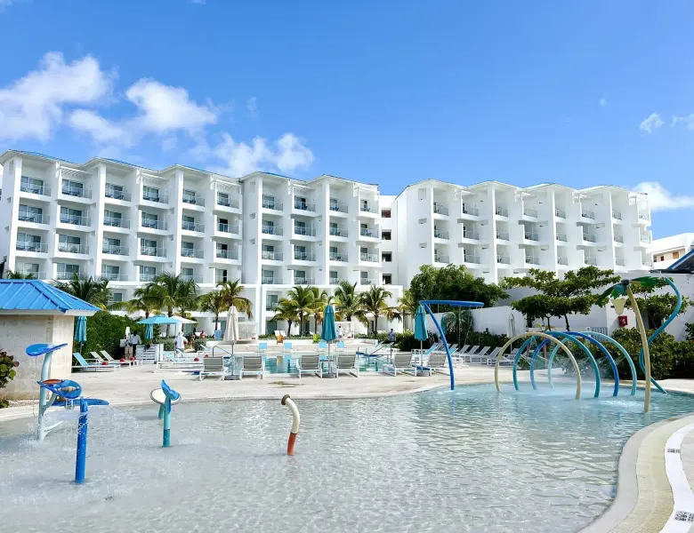 Waterpark with slides, pool, and white resort building